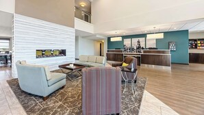 A spacious lobby with a reception desk, seating area, and a staircase. - Best Western Plus Bolivar Hotel & Suites (Bolivar)