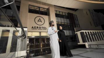 A modern building with a sign for the Aerotel Airport Transit Hotel.