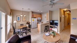A compact living space with a dining area, kitchen, and seating area.