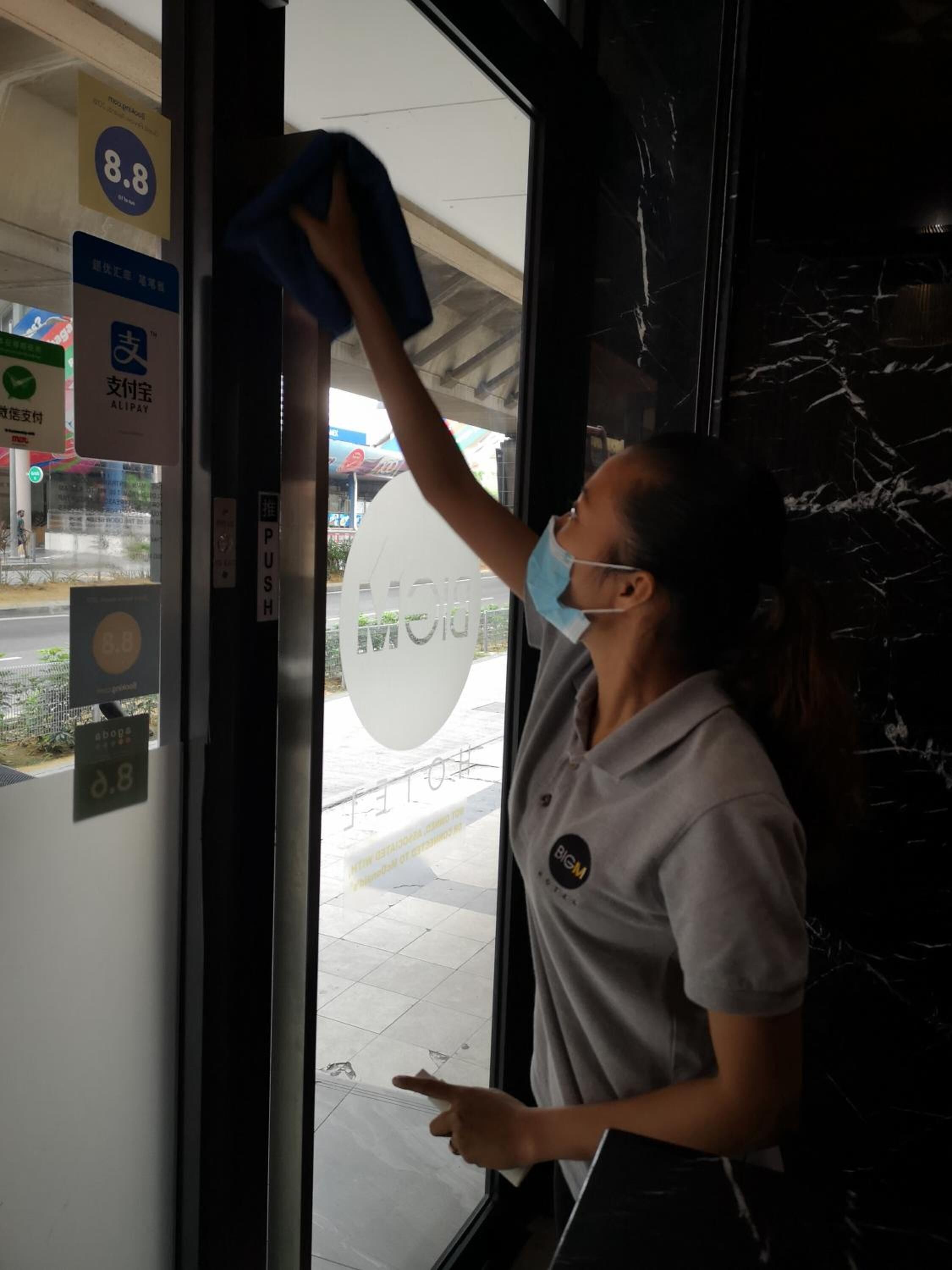 A person cleaning a window with a squeegee.