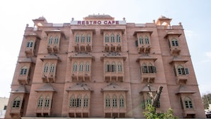 A building with a sign reading "RESTBO CAFE" at the top. - Hotel Castle Inn (Udaipur)