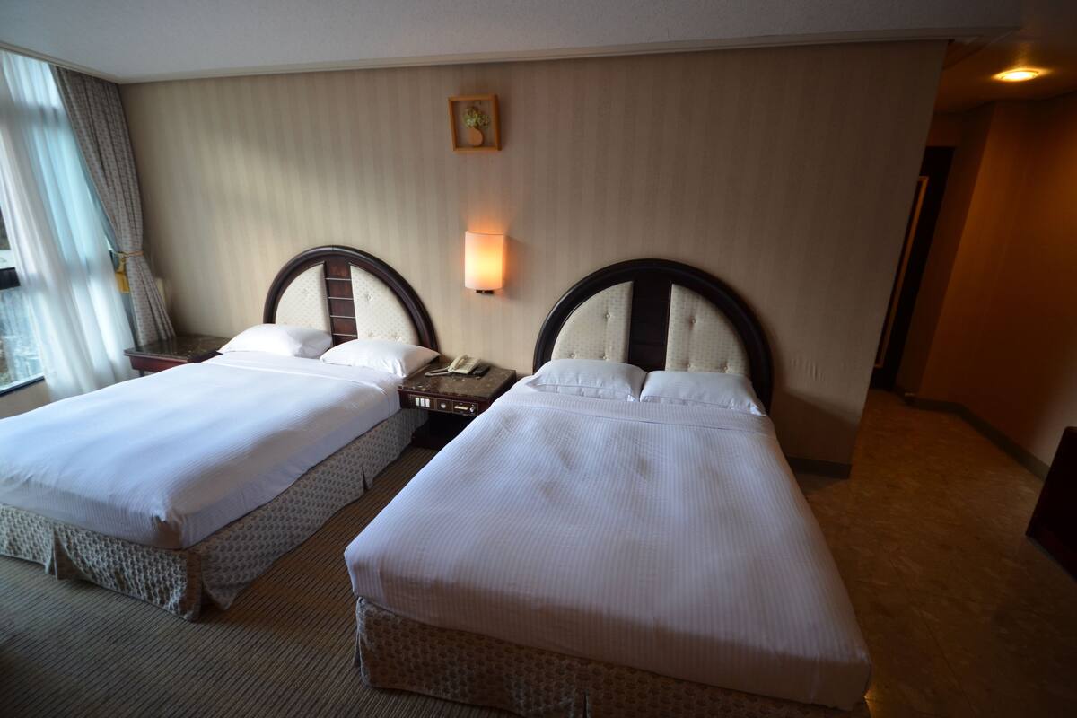 Deluxe Quadruple Room | Desk, WiFi (free), bed sheets