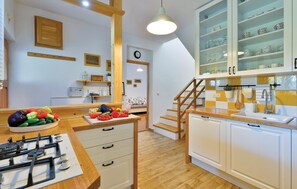 Fridge, stovetop, dishwasher, coffee/tea maker