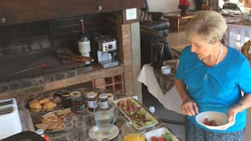 A breakfast buffet with various food items and a coffee machine.