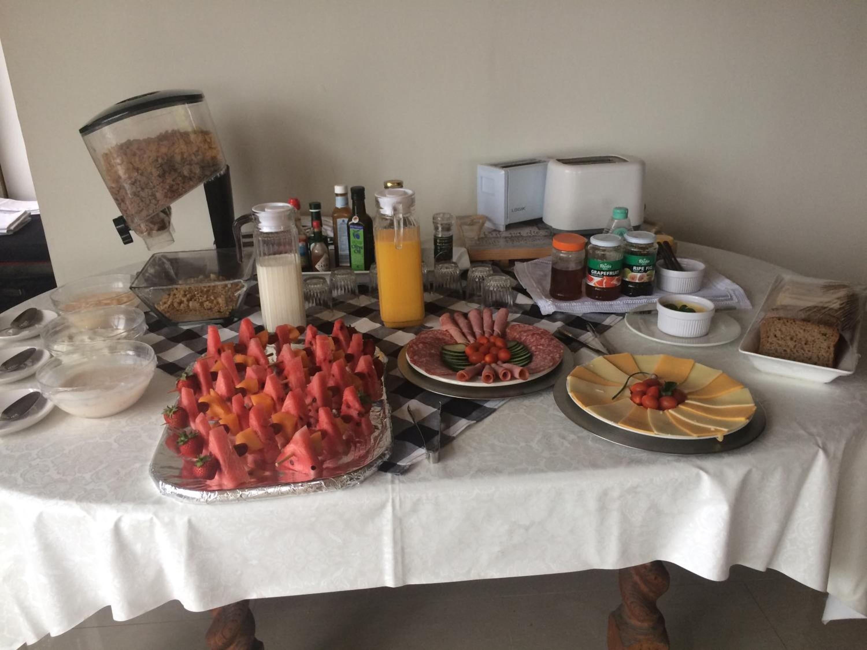 A breakfast buffet with various food items and beverages.