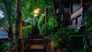 A wooden staircase surrounded by lush greenery, leading to a building with a traditional design. - Chareena Hill Resort - Pattaya Beach Koh Lipe (Koh Lipe)