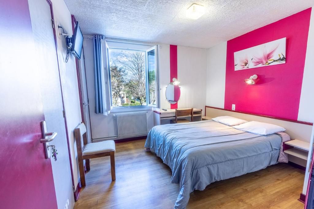 A bedroom with a bed, a chair, a window, a radiator, and a wall with a picture.