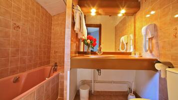 A bathroom with a bathtub, sink, and toilet.