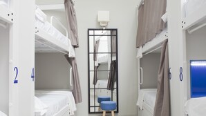 A room with bunk beds, a mirror, and a stool. - Málaga Stop Hostel (Málaga)