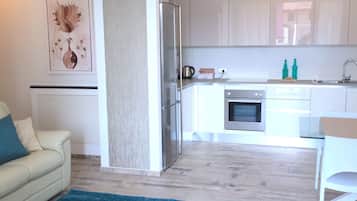 Apartment, 2 Bedrooms (4) | Living area | 32-inch flat-screen TV with cable channels, TV, heated floors