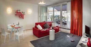 Apartment, 1 Bedroom | Living area | 32-inch flat-screen TV with cable channels, TV, heated floors - Rivetto Suites (Alba)