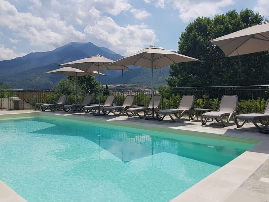 Seasonal outdoor pool, open 10:00 AM to 8:00 PM, pool umbrellas