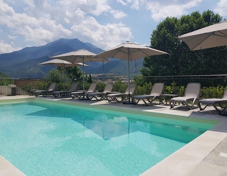 Seasonal outdoor pool, open 10:00 AM to 8:00 PM, pool umbrellas