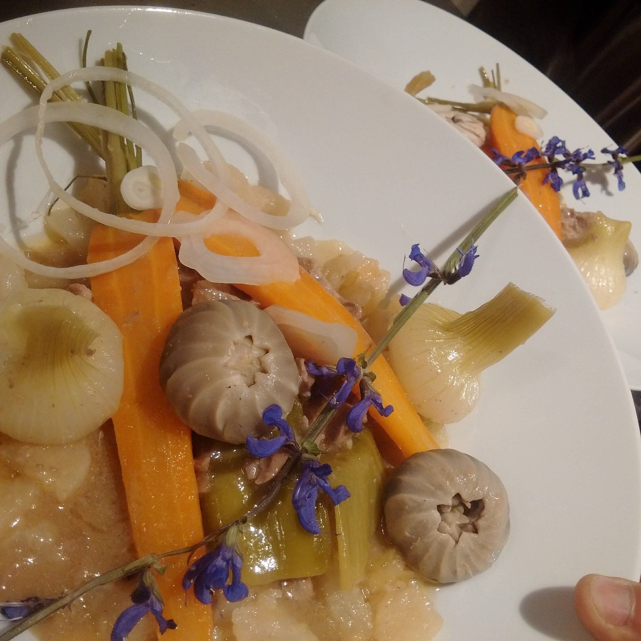 A plate of food with vegetables and flowers.