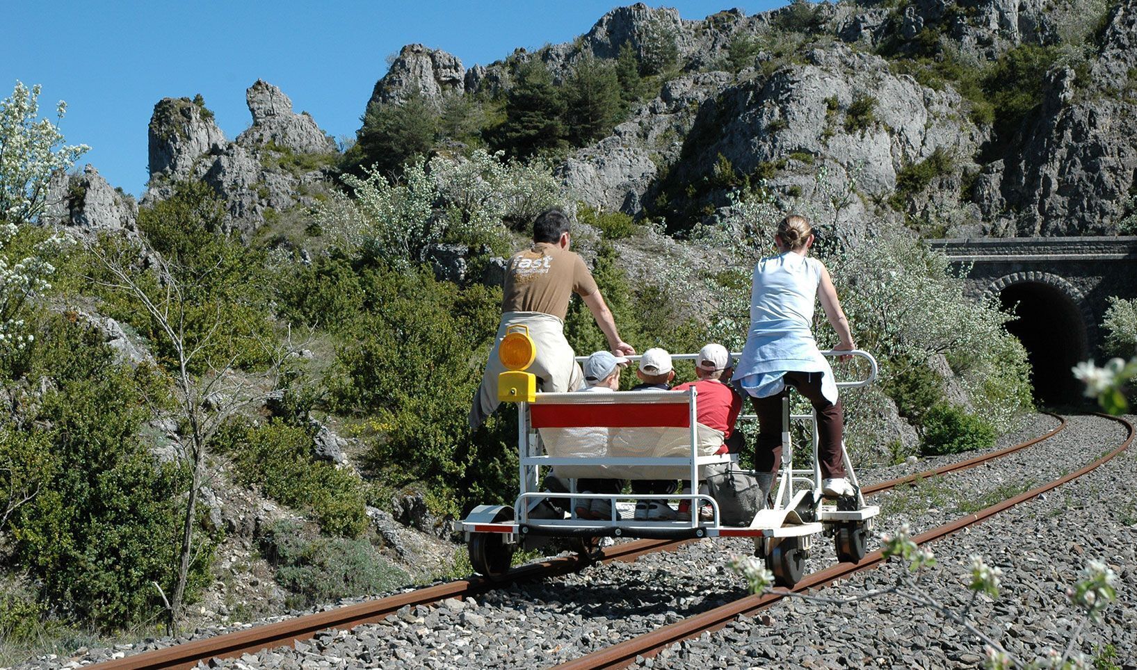 A railway track with a cart carrying passengers.