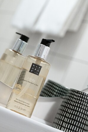 Two bottles of hand wash soap on a white surface with a checkered cloth in the background. - Landhaus vor Burg Eltz (Wierschem)