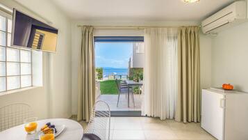 Deluxe Apartment, Sea View (Ground floor) | Living area | Flat-screen TV