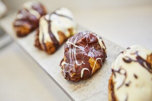 A row of pastries on a tray. - Santorini Main Square (Santorini)