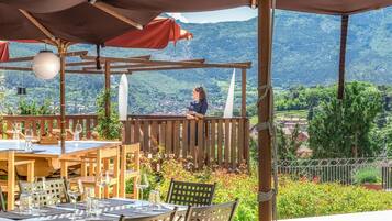 Enjoy a tranquil dining experience amidst lush green surroundings.