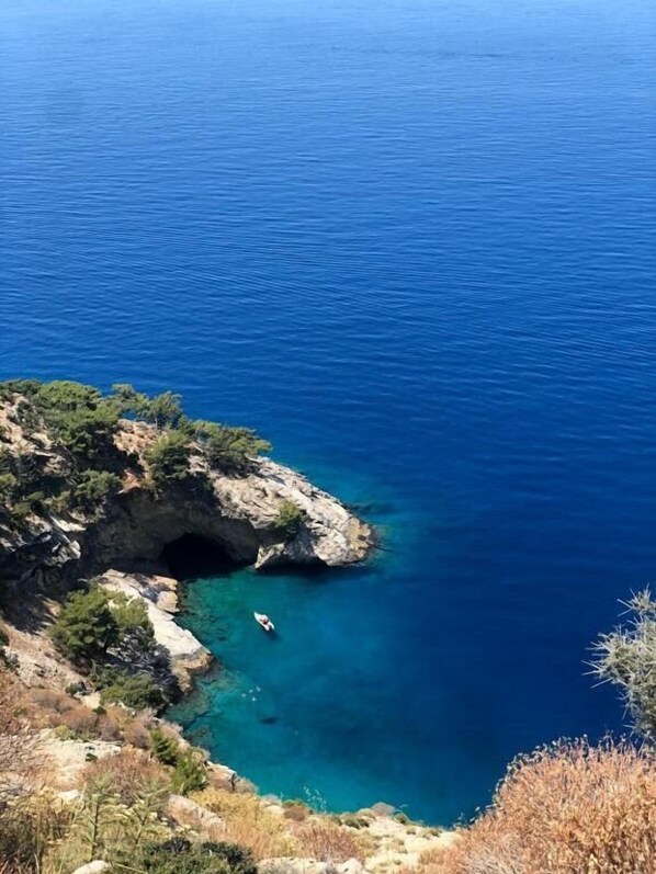 A coastal landscape with a rocky outcrop and a clear blue sea. - Mimoza Hotel (Fethiye)