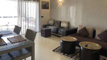 Apartment, 1 Bedroom, Pool View | Living room | Flat-screen TV