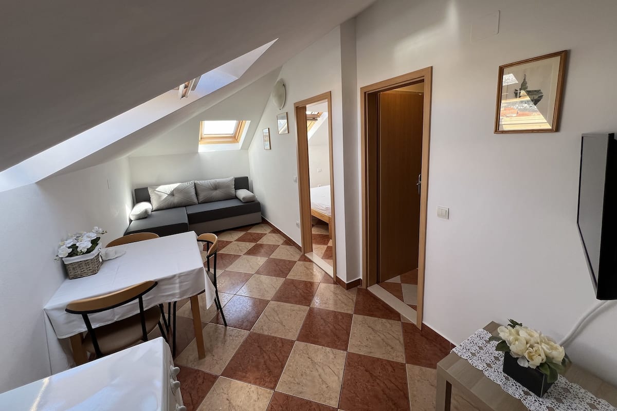 Apartment, 1 Bedroom (Attic) | Living area | Flat-screen TV