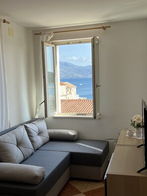Apartment, 1 Bedroom, Sea View | Living area | Flat-screen TV