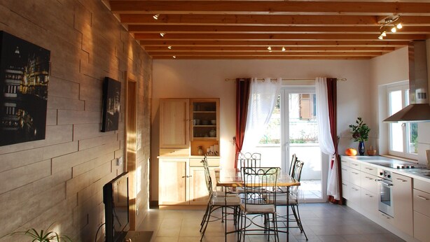A spacious loft with a wooden staircase, a dining area, kitchen, and a large skylight. - New Kertzfeld cottage, luxury performance in Alsace countryside. (Kertzfeld)