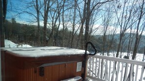 A wooden hot tub on a deck with a white railing, surrounded by snow-covered ground and trees. - 2026-27 dates available! Mountain biking or hiking the Green Mtn, or ski Okemo! (Ludlow)