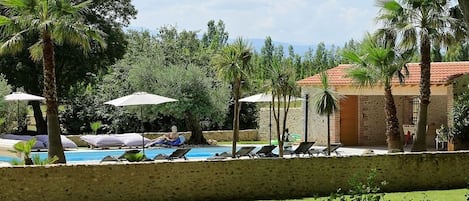 Outdoor pool, a heated pool, sun loungers