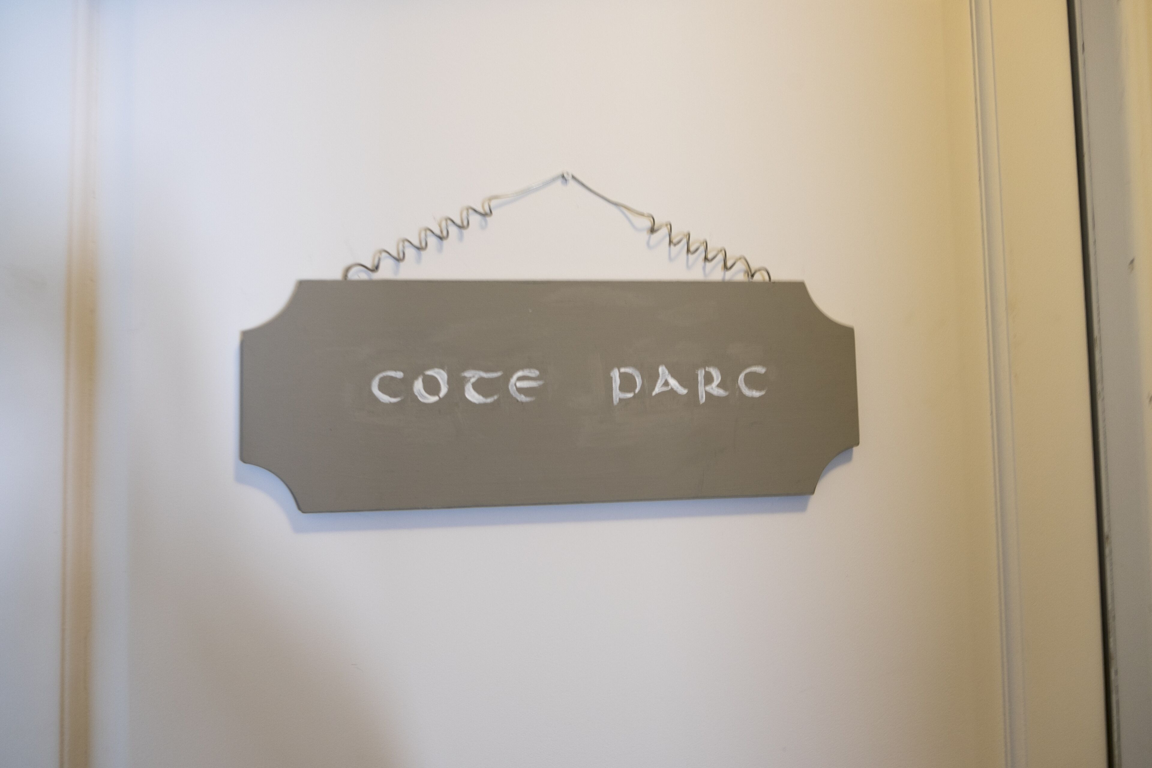 A sign with the text "COTE D'ARC" mounted on a wall.