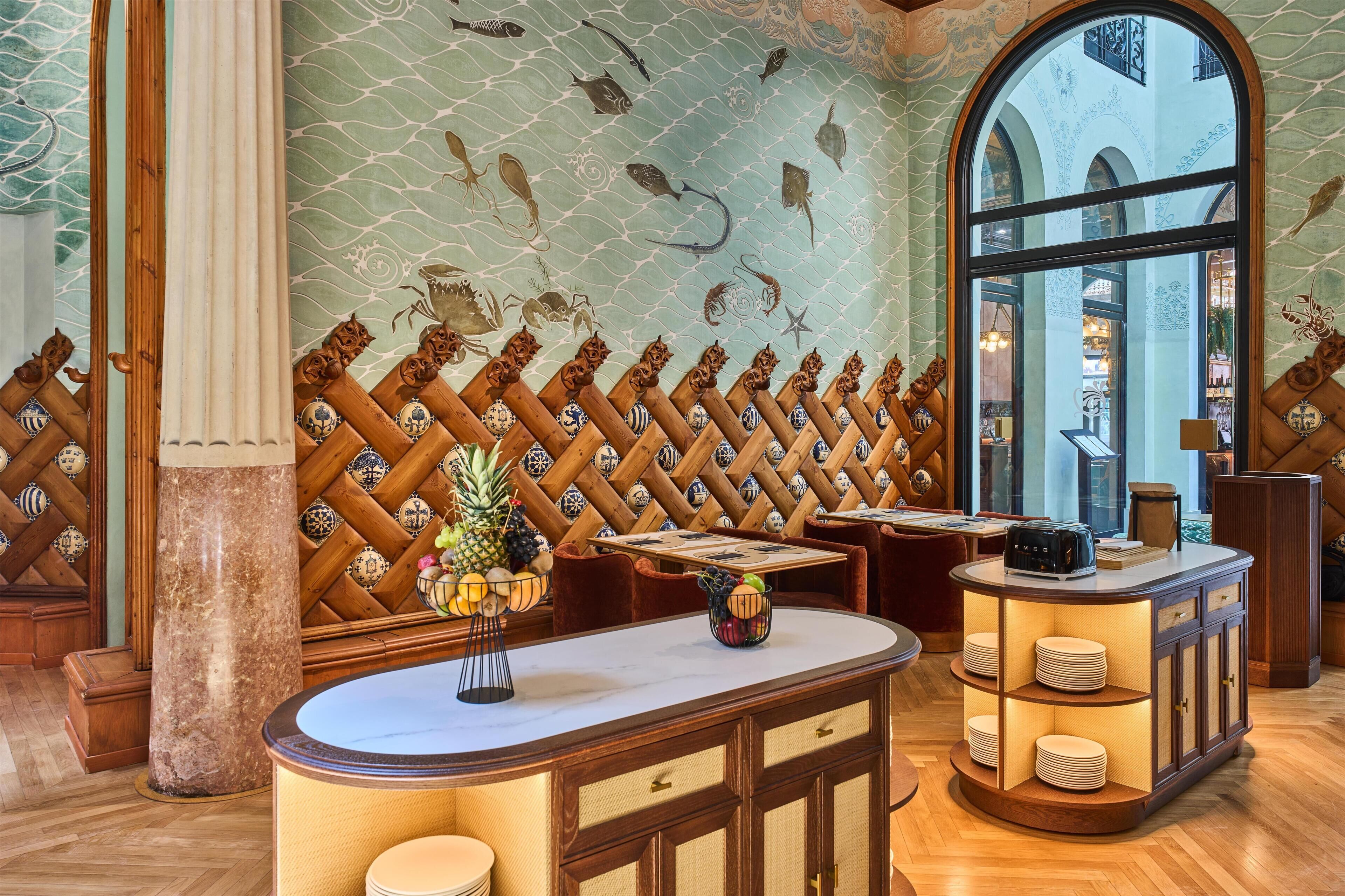 A restaurant interior with a wooden lattice wall, a marble counter, and a view through a large arched window.