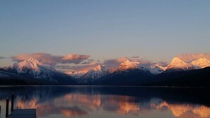 A mountain range reflected in a calm lake with a clear sky. - Little House Under the Big Sky, 2 bedrm 2 bth near Glacier Park & Whitefish Mt. (Columbia Falls)
