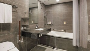 Ein modernes Badezimmer mit Badewanne, Dusche und Waschbecken.