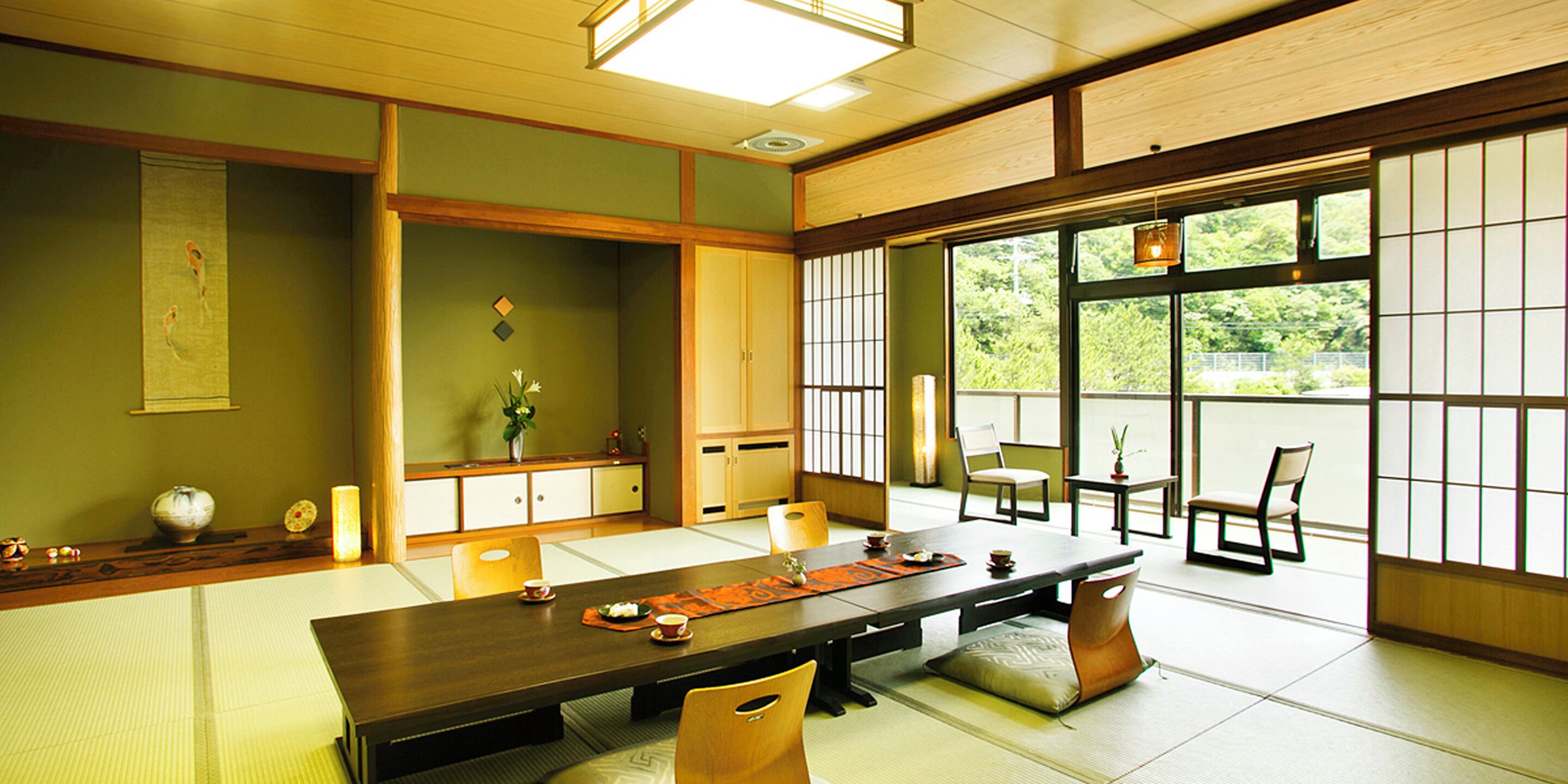 A traditional Japanese room with tatami flooring, a low table, and sliding doors.
