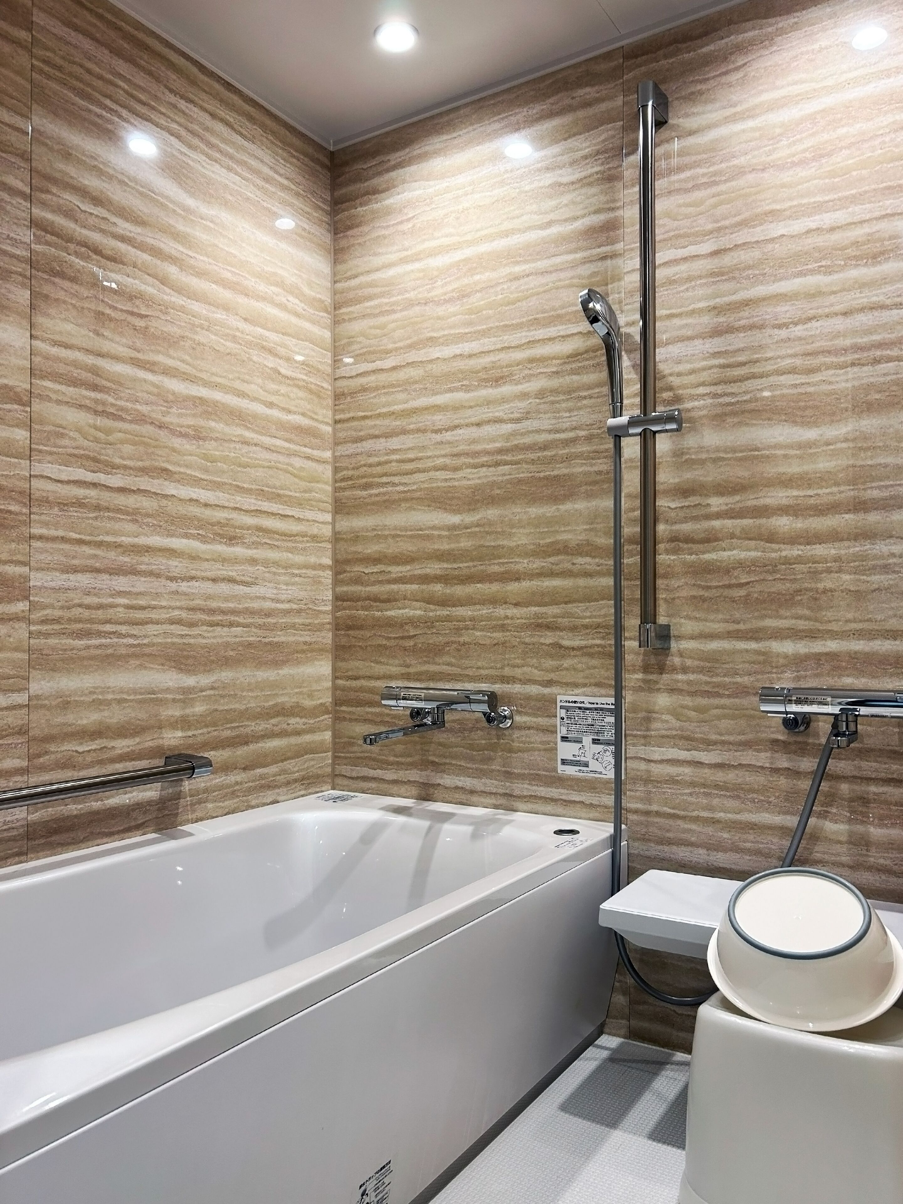 A modern bathroom with a large bathtub, a glass shower enclosure, and a vanity with a mirror.