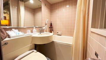 A bathroom with a sink, toilet, and bathtub.