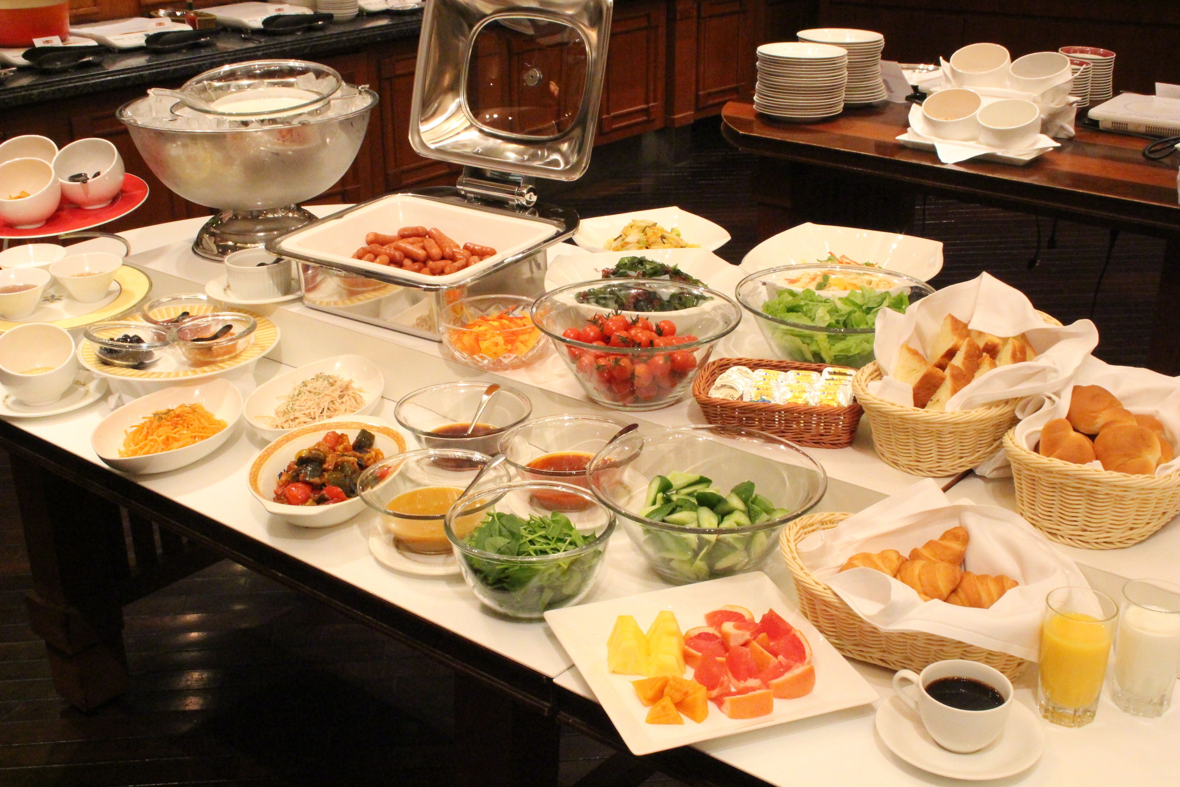 A buffet with various food items and beverages.