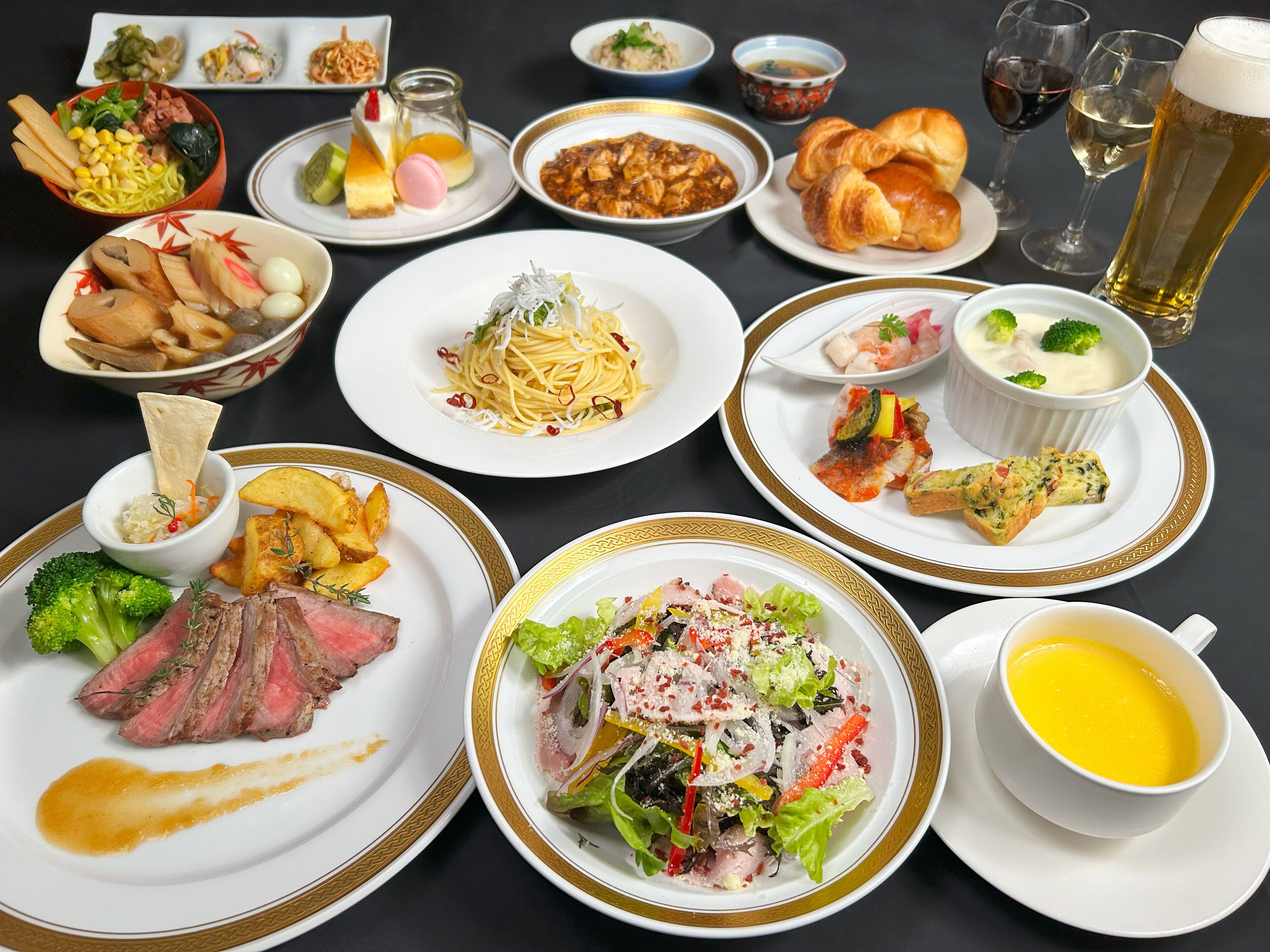 A variety of dishes including steak, pasta, and seafood, suggesting a fine dining experience.