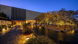A modern building with a reflective water feature in front. - Hamadachidori no Yu Kaishu (Shirahama)