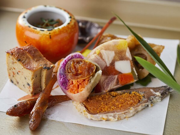 A variety of food items including a baked dish, a stuffed tomato, and a fish fillet. - Kamenoi Hotel Hikone (Hikone)