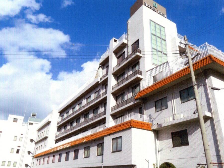 A multi-story hotel with balconies and a prominent sign indicating it is a hotel.