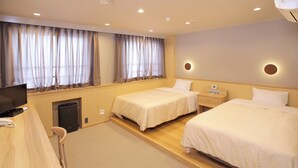 A hotel room with two beds, a TV, a desk, and a small kitchenette. - Yamaguchi Grand Hotel (Yamaguchi)