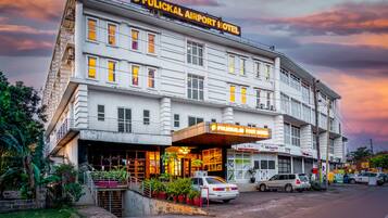 A hotel with a sign reading "Pulical Airport Hotel" and a visible entrance.