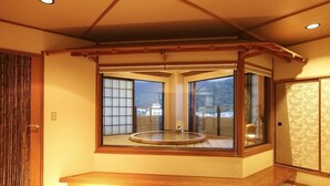 A traditional Japanese room with tatami flooring, a wooden ceiling, and large windows offering a view of a snowy landscape. - Toi Onsen Suishoutei (Izu)