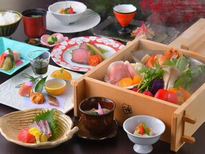 A variety of Japanese dishes including sushi, sashimi, and a hot pot, served on a wooden table with traditional bowls and chopsticks. - Nikko Chuzenji-ko Onsen Hotel Hana-An (Nikko)