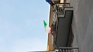 A building with a sign for "PENSIONE Aurora Ultimo Piano".