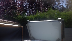A hot tub with a wooden exterior, a control panel, and a label reading "Solitude Spa." - Chez Colombine (Chaponost)