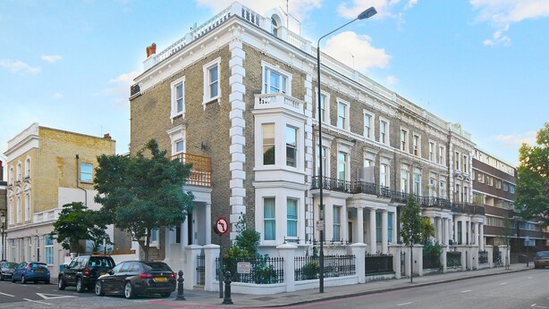 A row of traditional terraced houses with white facades, a no parking sign, and a street lamp. - Belgravia Apartments - Cathcart Road (London)