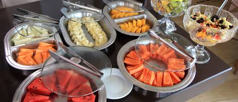 A buffet with various fruits and vegetables.